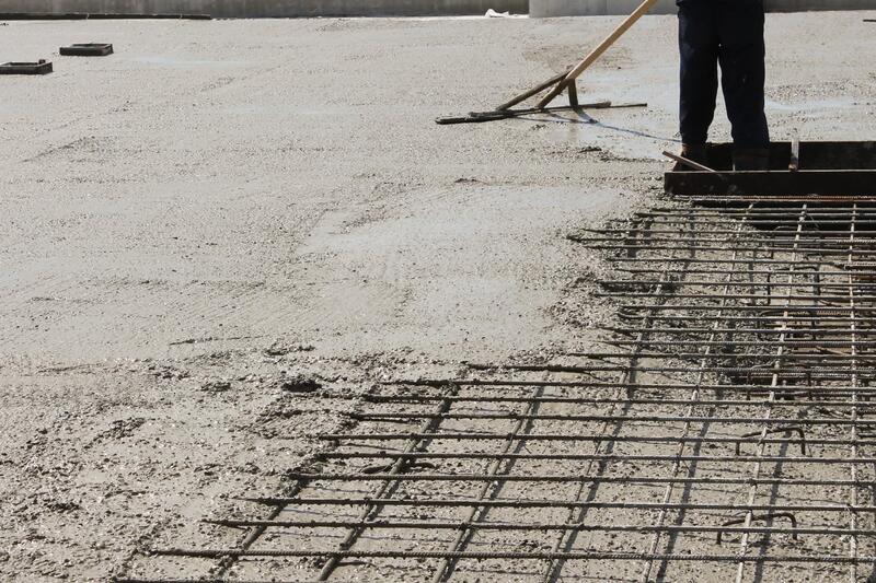 professional concrete worker working on concrete walkways 
